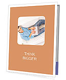 Portrait of a man relaxing on couch while using a laptop Presentation Folder