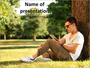 Man Sitting under the Ttree with Tablet PowerPoint Template