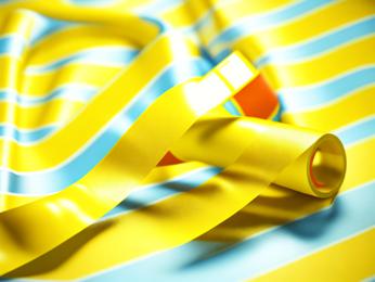 A close up of a yellow ribbon on a blue and yellow background PowerPoint Template