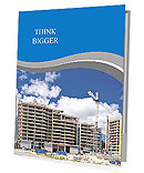 High-rise building under construction. The site with cranes against blue sky Presentation Folder